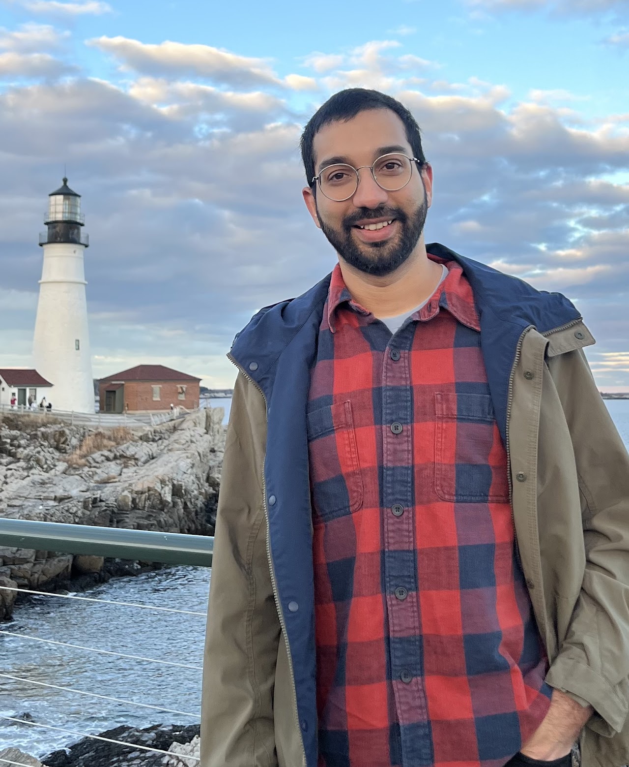 Kaustubh Ghoshal standing in front of a lighthouse